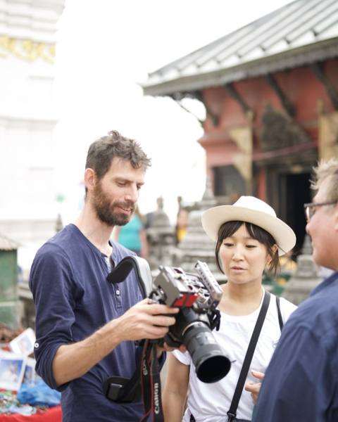 The cinematographer showing footage on his camera to Aya Takano at Swayambhunath