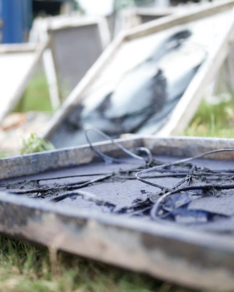 Black cable pressed into dark grey pulp on a mould