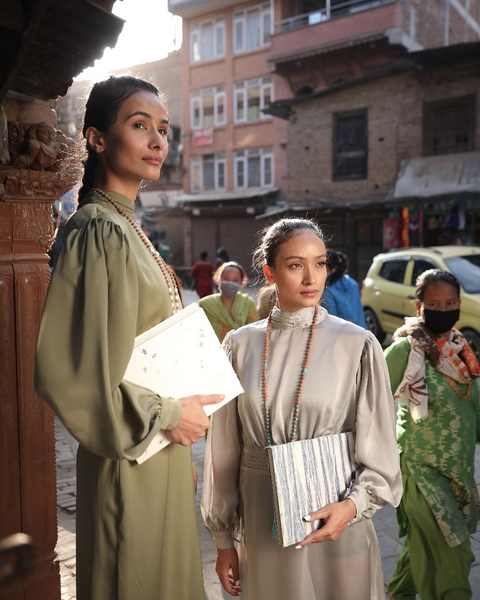 Two models in Bhaktapur holding lokta paper portfolios