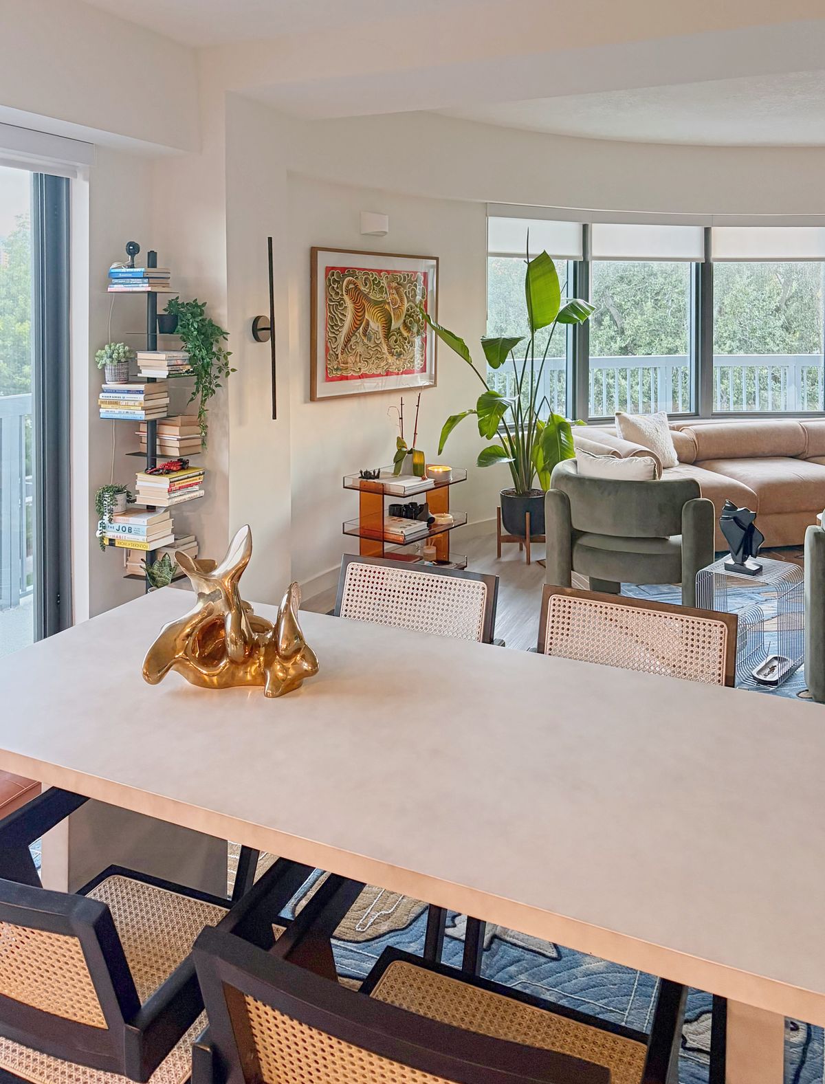 A gold sculpture on the dining table by the window