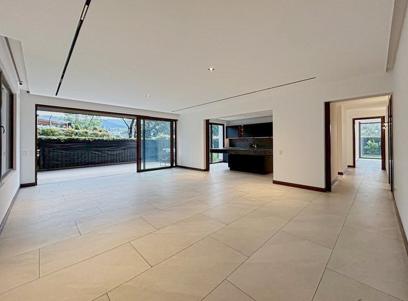 The empty apartment: a long living room opening to the terrace and the kitchen